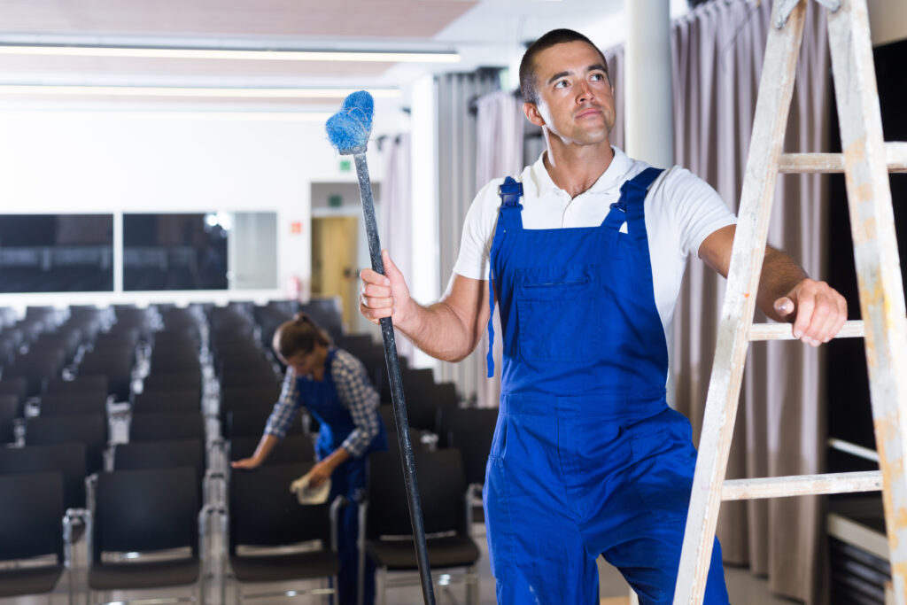 Man and woman preparing conference hall