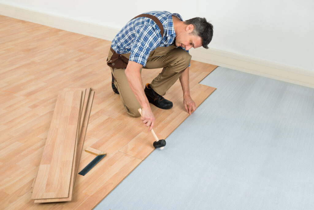 Man Installing New Laminated Wooden Floor